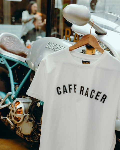 BSMC Cafe Racer T-Shirt - White hanging from motorcycle