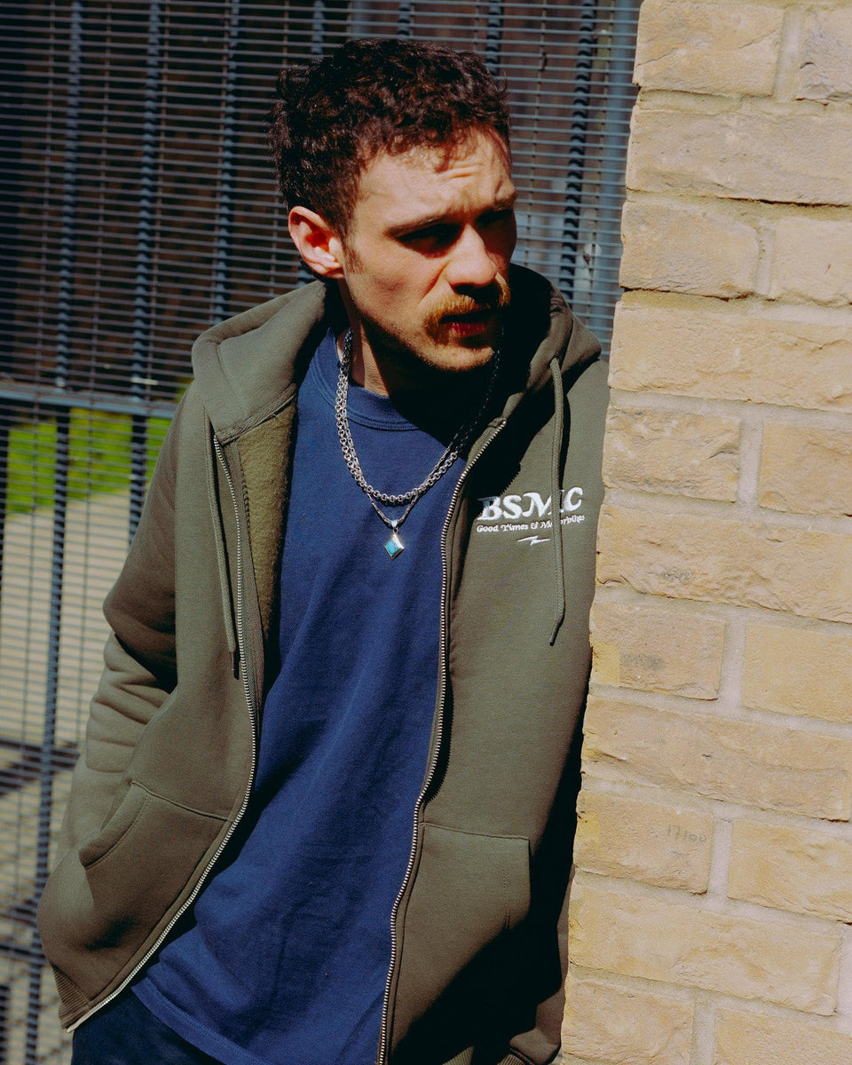 model wearing green Bike Shed Motorcycle Co. Good Times Hooded Sweatshirt 